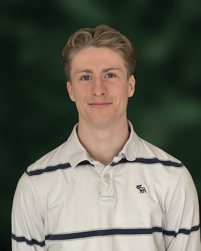 Henry Adams, smiling, in a white striped polo shirt.