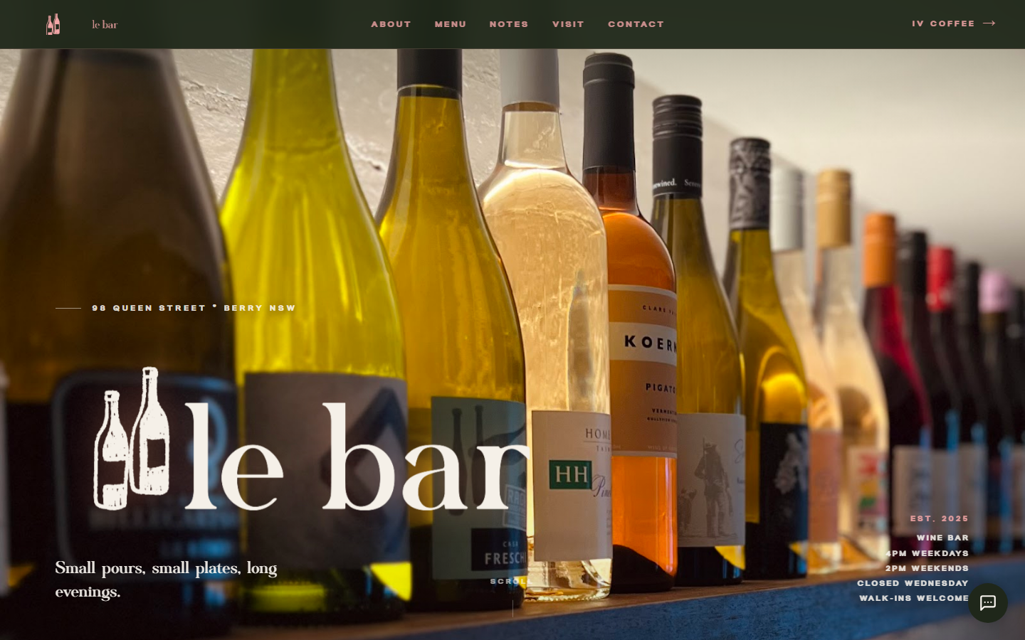 The le bar homepage, showing a backlit row of wine bottles behind the le bar wordmark.